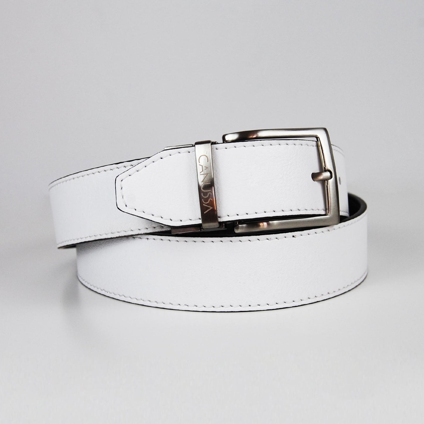 White black reversible belt with a silver buckle on a white background