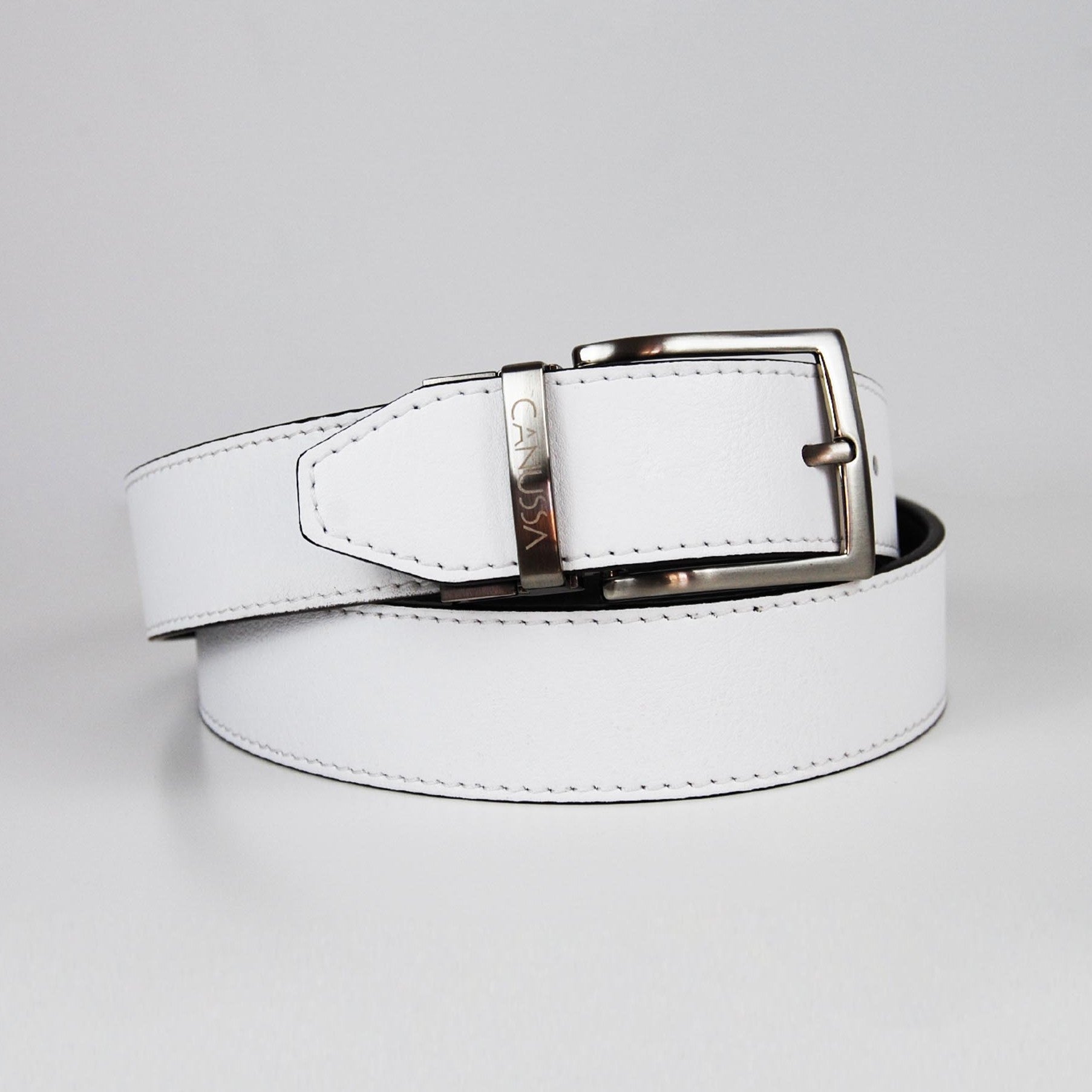 White black reversible belt with a silver buckle on a white background